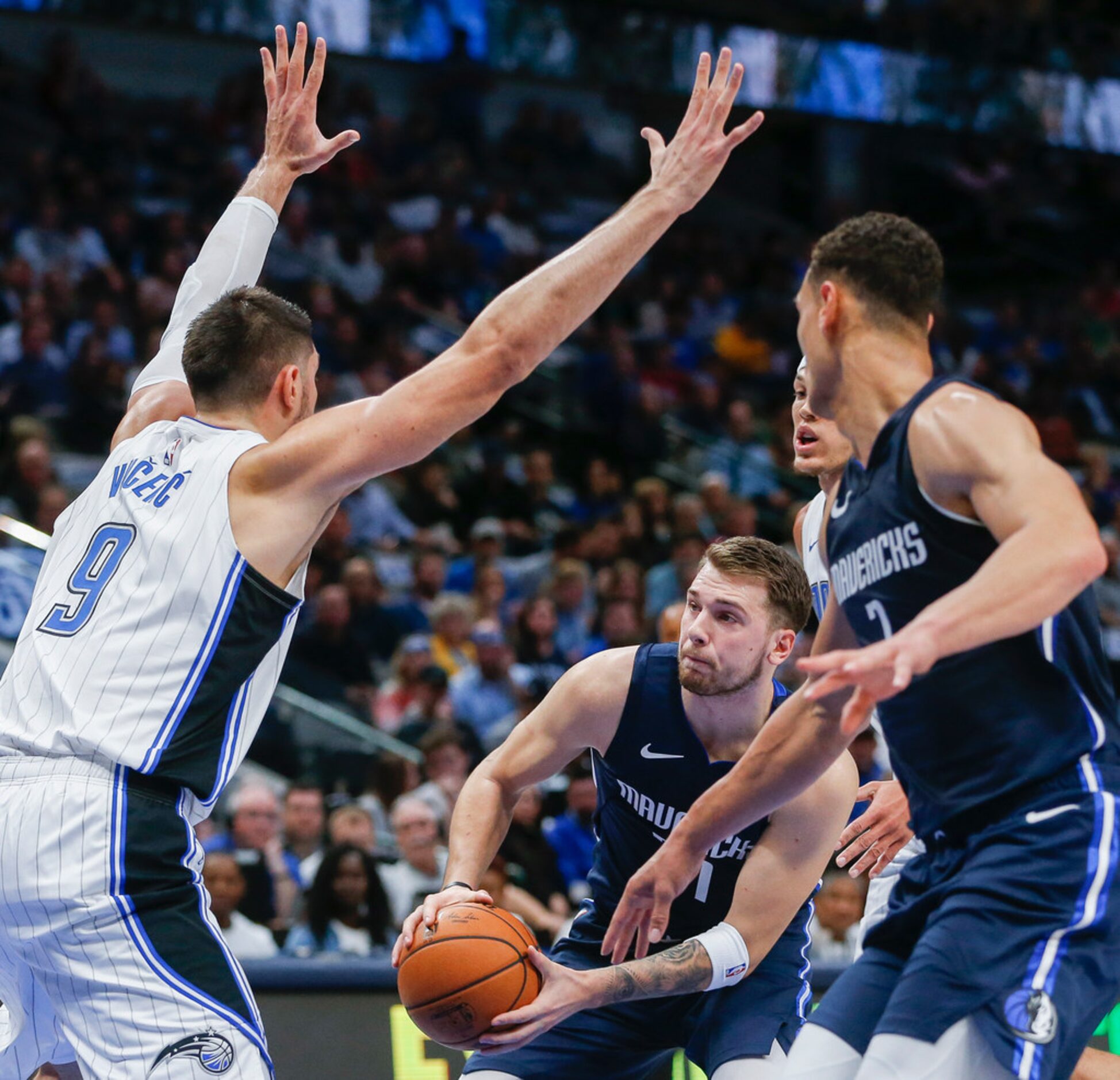 Dallas Mavericks guard Luka Doncic (77) looks for a lane to the basket past Orlando Magic...