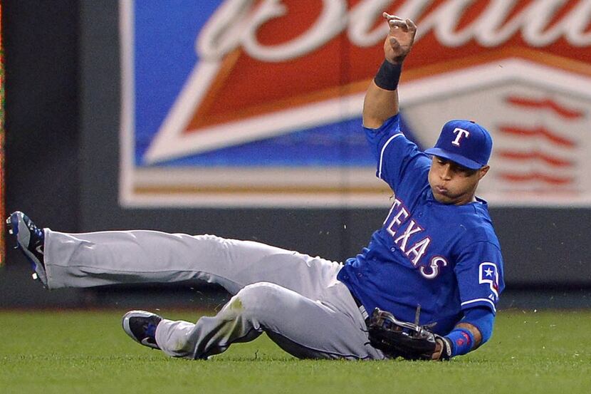 Texas Rangers center fielder Leonys Martin misses a sliding attempt on an RBI double by the...