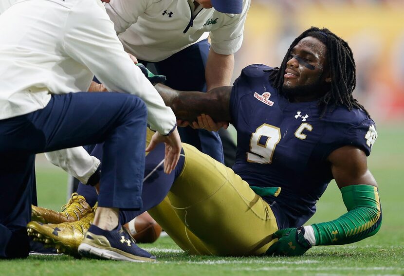 GLENDALE, AZ - JANUARY 01:  Linebacker Jaylon Smith #9 of the Notre Dame Fighting Irish lays...