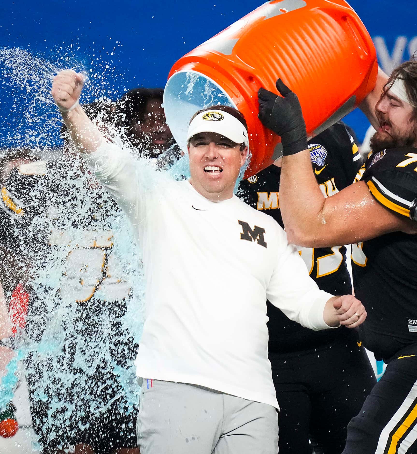 Missouri head coach Eliah Drinkwitz is doused by offensive lineman Mitchell Walters (75)...