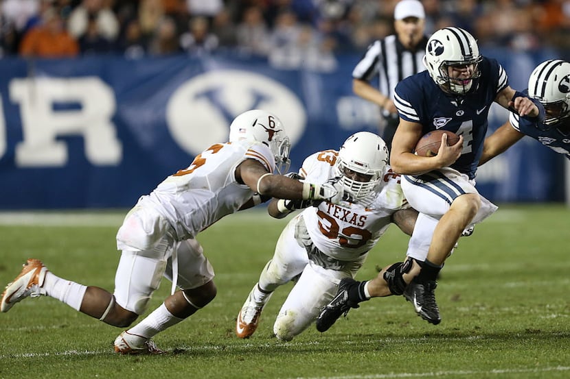 PROVO, UT - SEPTEMBER 7: Quarterback Taysom Hill #4 of BYU Cougars runs through tackles by...