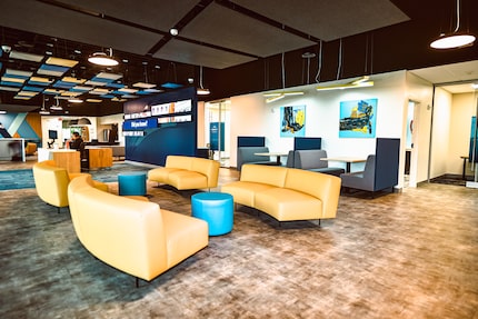 Interior of a meeting and working space with couches, tables, and office equipment