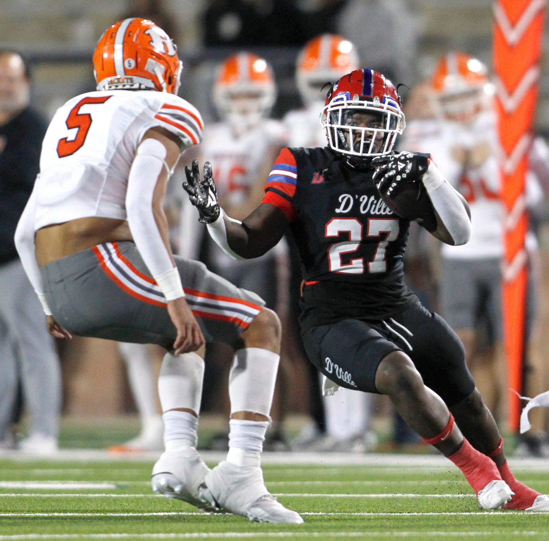 Duncanville running back JaQualon Armstrong (27), right, makes a cut to avoid the defensive...