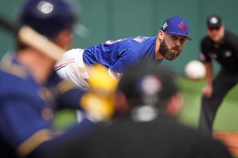 Texas Rangers pitcher Joe Barlow delivers during the third inning of a spring training game...