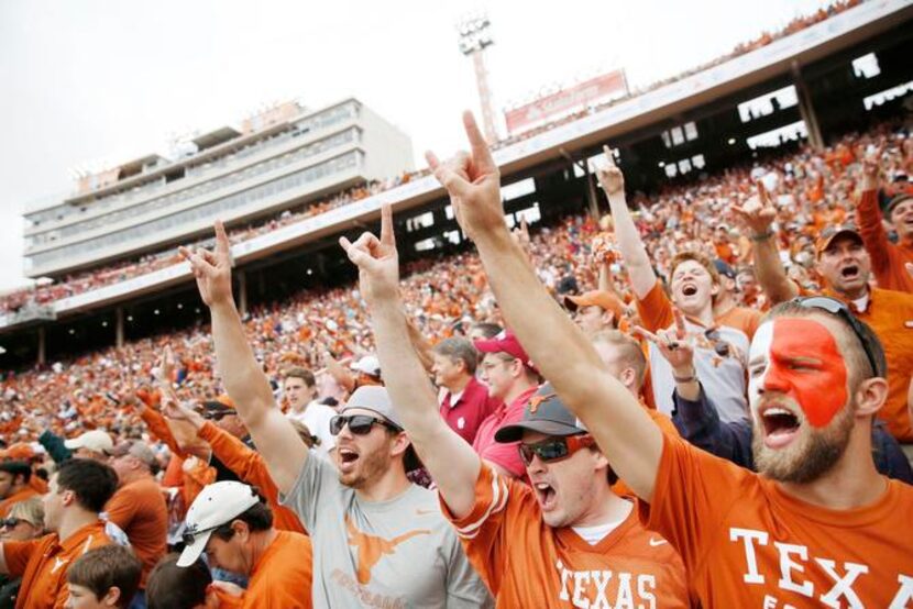 
Texas fans (from left) Dylen Ziton of Justin and Randy Hamm and Matt Nelson of Denton held...