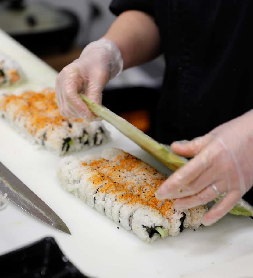 Anne Mosley makes fresh sushi at the Joe V's Smart Shop store in Pasadena. Customers started...