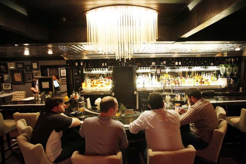 Men sit at the bar inside the Bowen House bar and restaurant in Uptown Dallas.  (Ben...