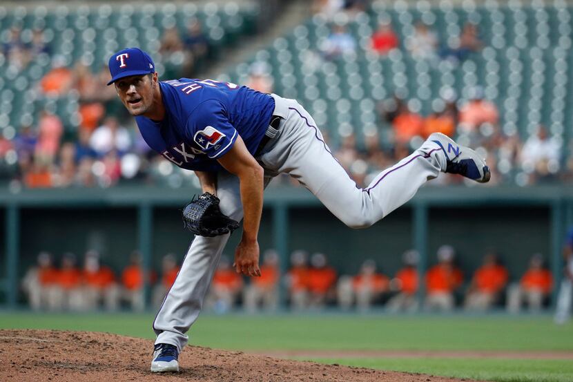 Texas Rangers starting pitcher Cole Hamels throws to the Baltimore Orioles during a baseball...
