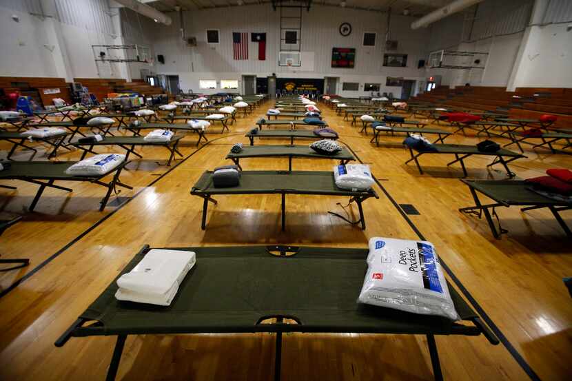 Cots await in an emergency shelter for evacuees and workers of the fertilizer plant...