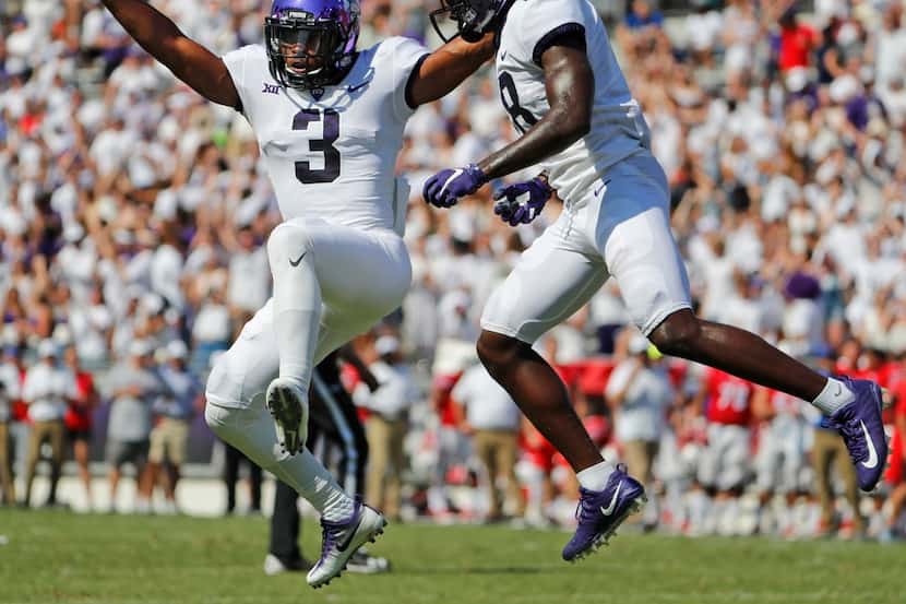 TCU Horned Frogs wide receiver Shaun Nixon (3) leaps in the air with wide receiver Jalen...