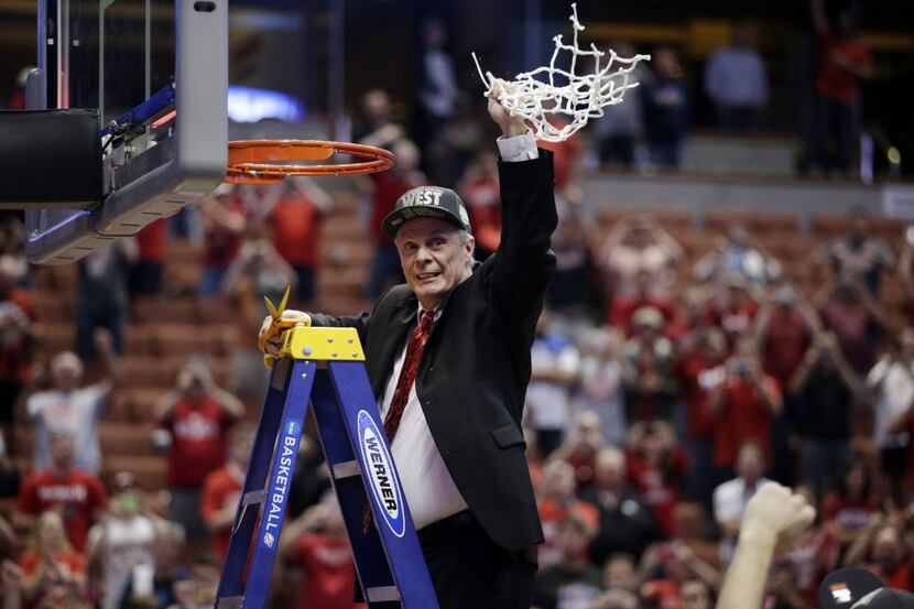 Wisconsin head coach Bo Ryan celebrates after cutting down the net after a regional final...