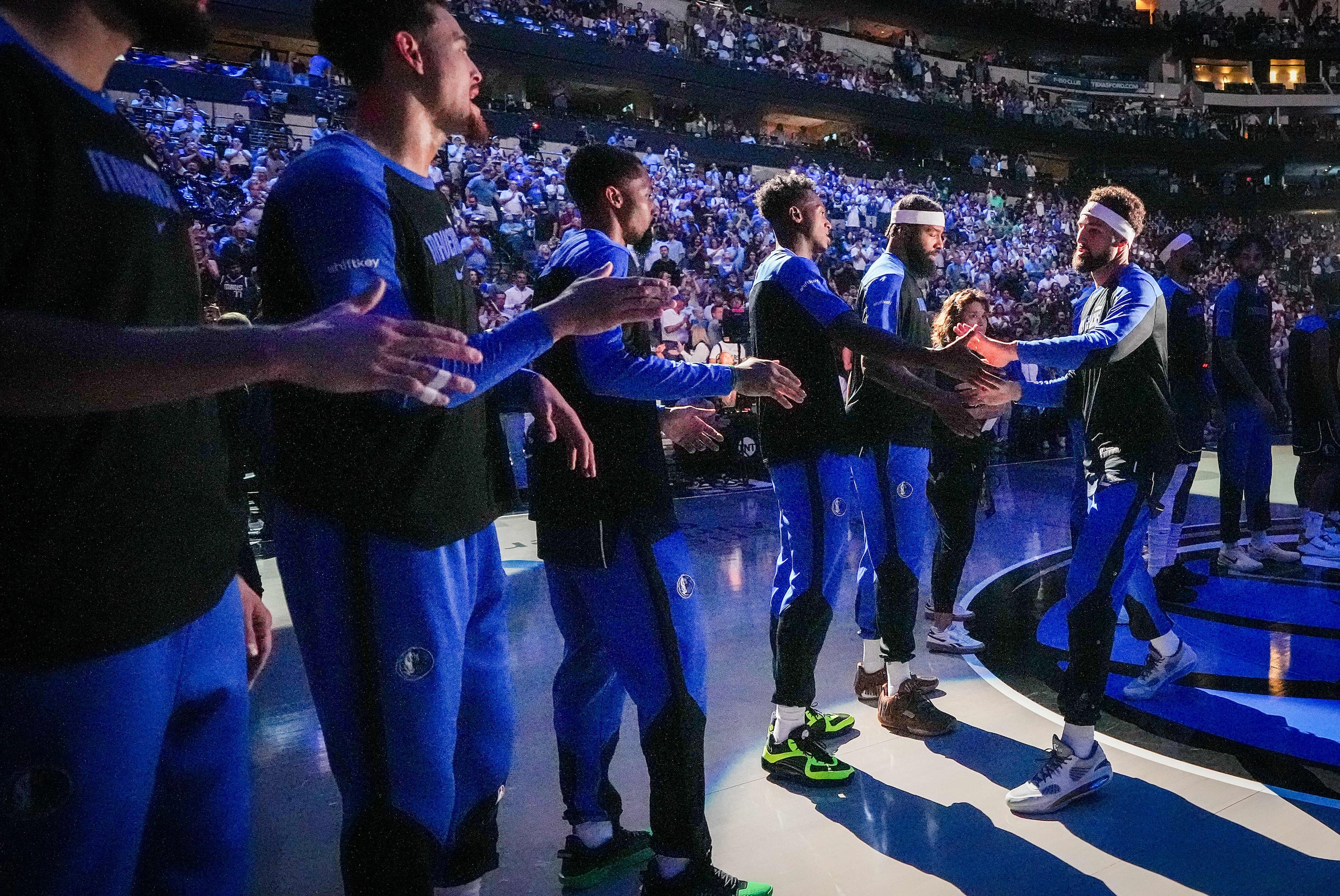 Dallas Mavericks guard Klay Thompson (right) greets his new teammates as he is introduced...