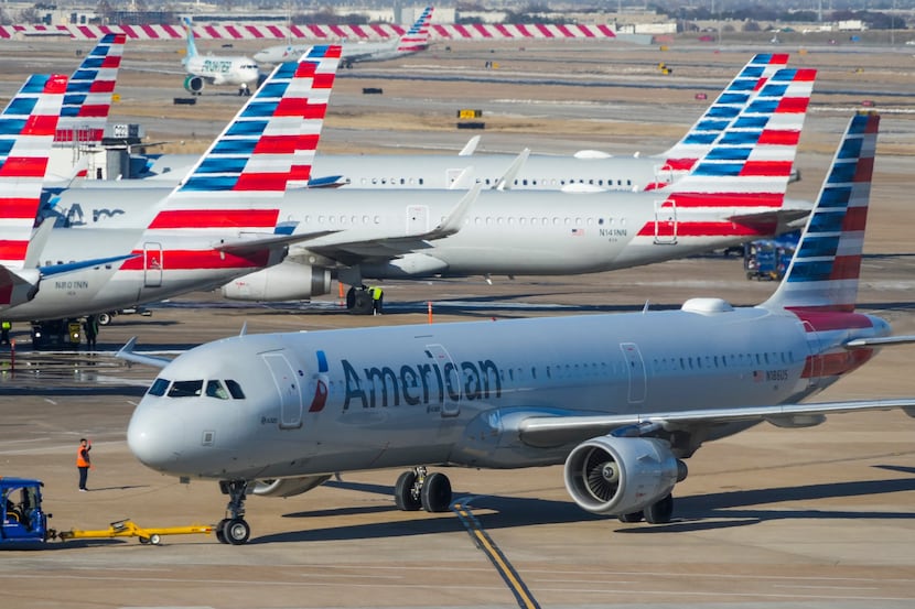 American Airlines planes are seen at the gates of Terminal C at DFW Airport on Friday, Feb....