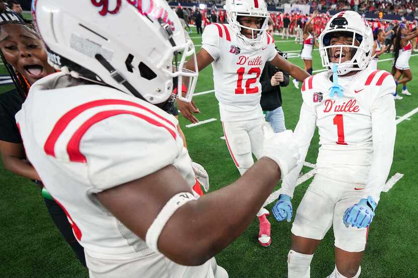 Duncanville’s Dakorien Moore (1) celebrates with Keelon Russell (12) and Javian Council (99)...