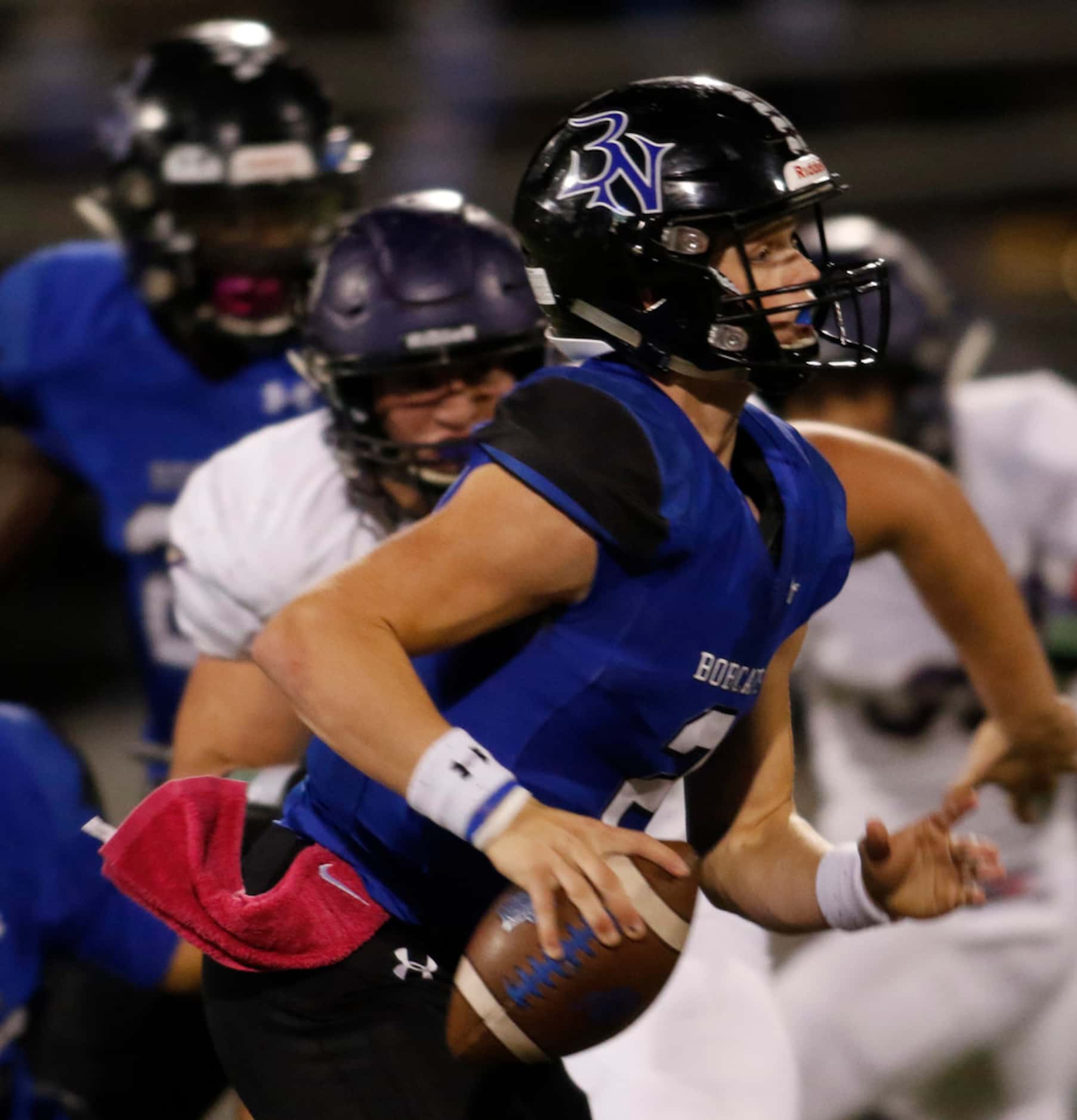 Trophy Club Byron Nelson quarterback Hudson White (2) is forced out of the pocket by an...