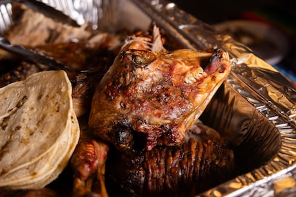 Cabrito cooked al ataud is shown alongside tortillas to make tacos.