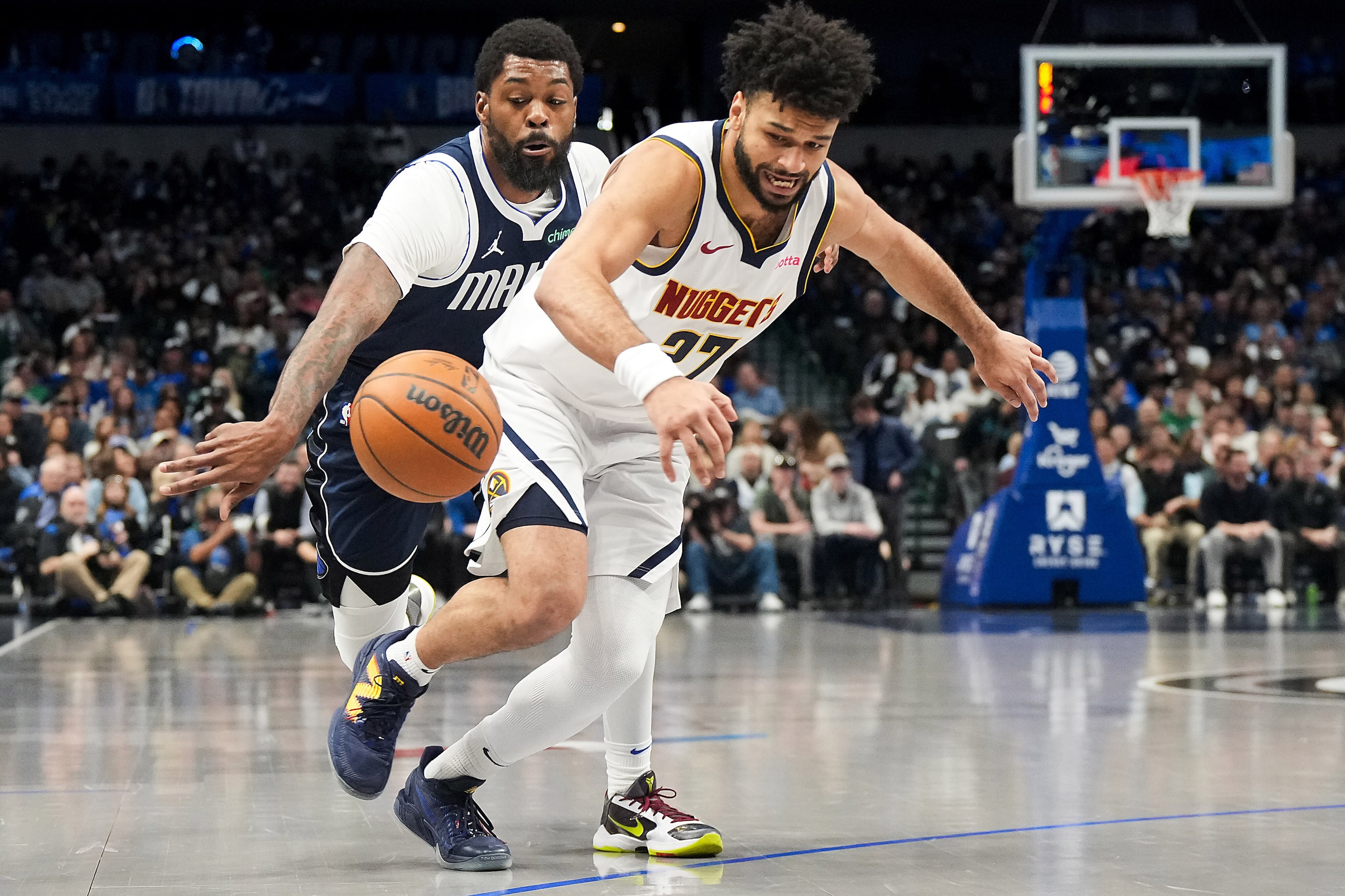 Dallas Mavericks forward Naji Marshall (13) knocks the ball away from Denver Nuggets guard...