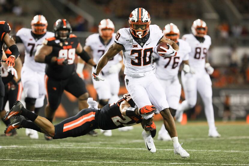 Oklahoma State wide receiver Gabe Simpson (30) is brought down by Oregon State defensive...