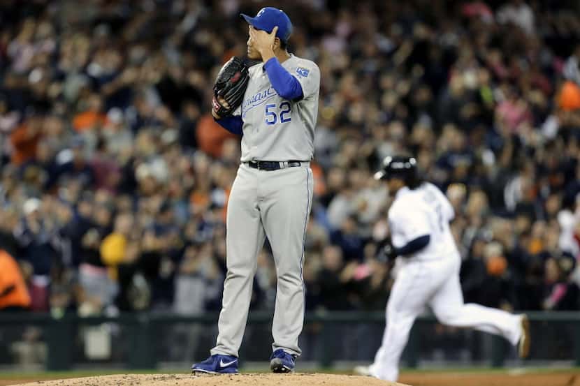Kansas City Royals relief pitcher Bruce Chen wipes his head after giving up a two-run home...