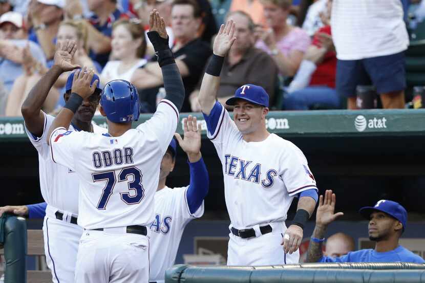 Texas Rangers second baseman Rougned Odor (73) is congratulated for a run scored by Texas...