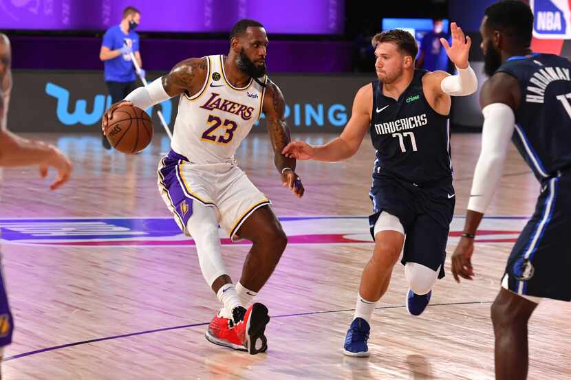 ORLANDO, FL - JULY 23: LeBron James (23) of the Lakers drives to the basket against Luka...