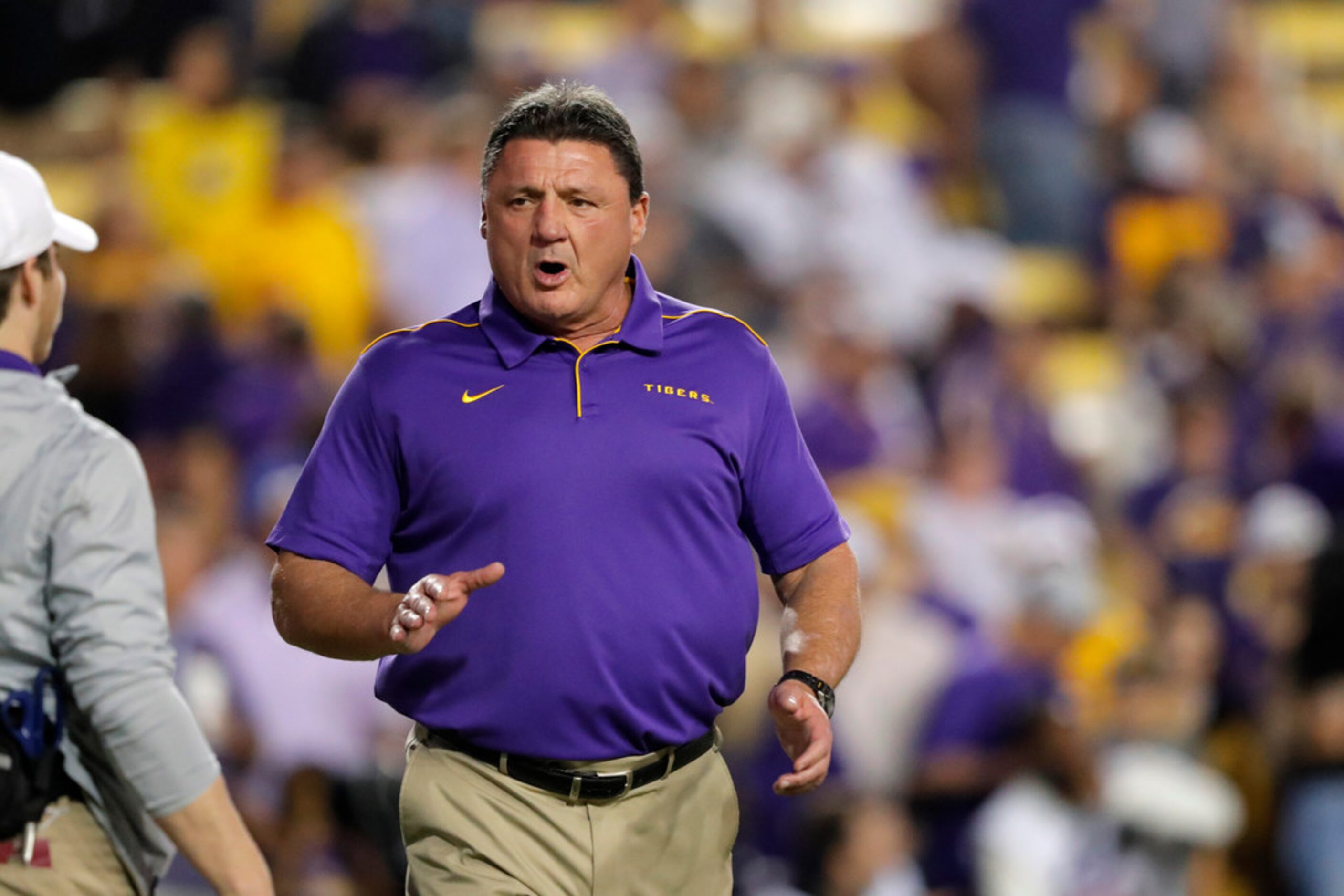 LSU head coach Ed Orgeron walks on the field before an NCAA college football game against...