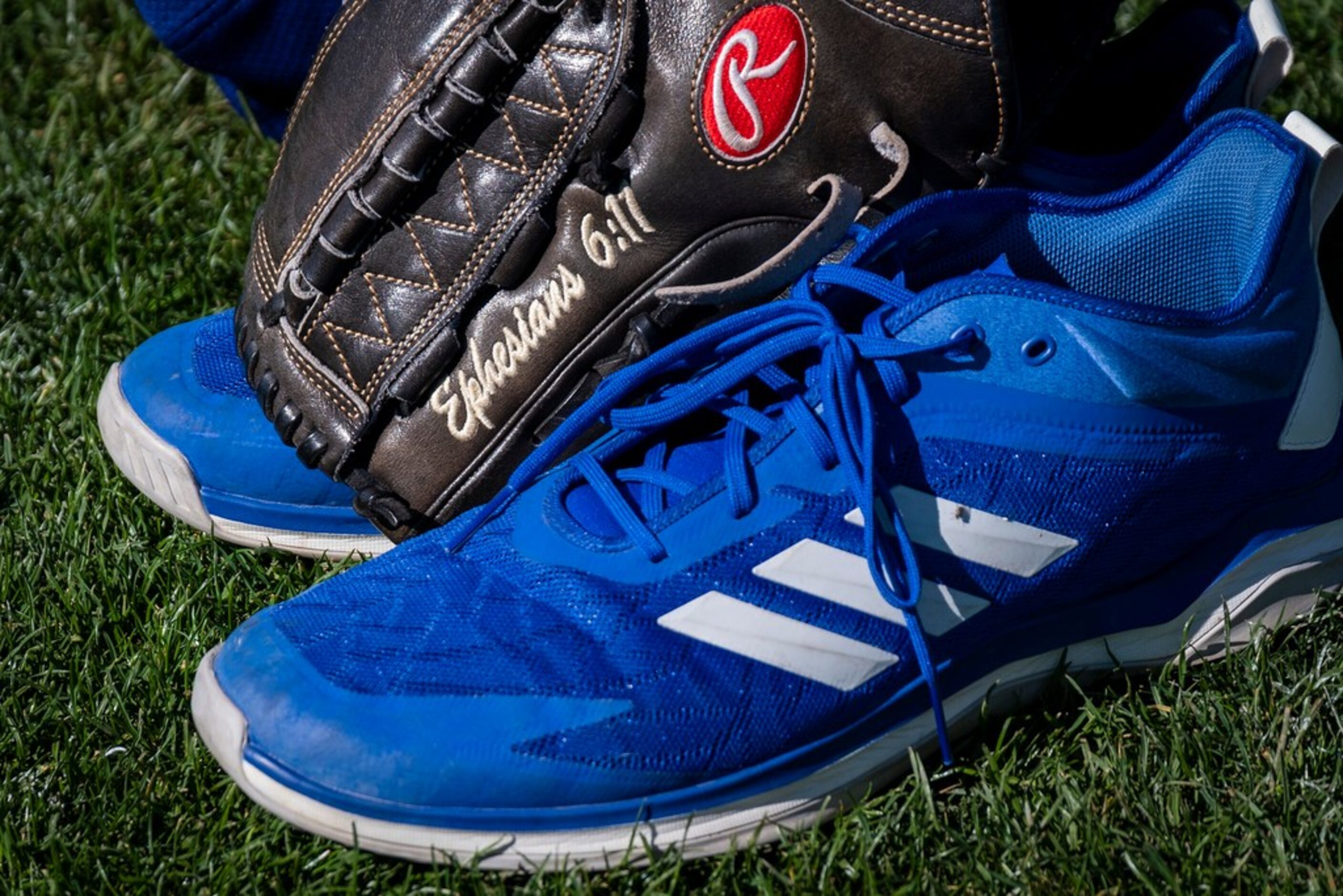 Texas Rangers pitcher Taylor Hearn's glove and shoes sit to the side during a spring...