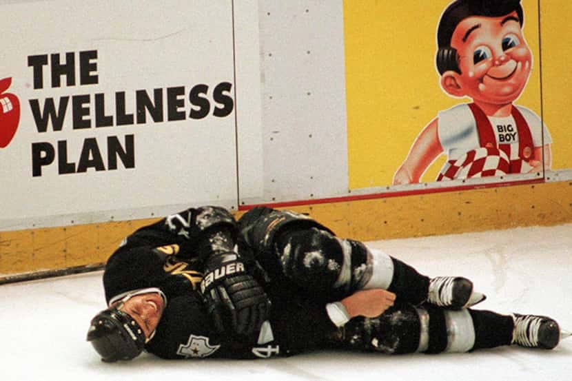 May 31, 1998âÂ Dallas Starsâ Richard Matvichuk (24) writhes on the ice in pain after...