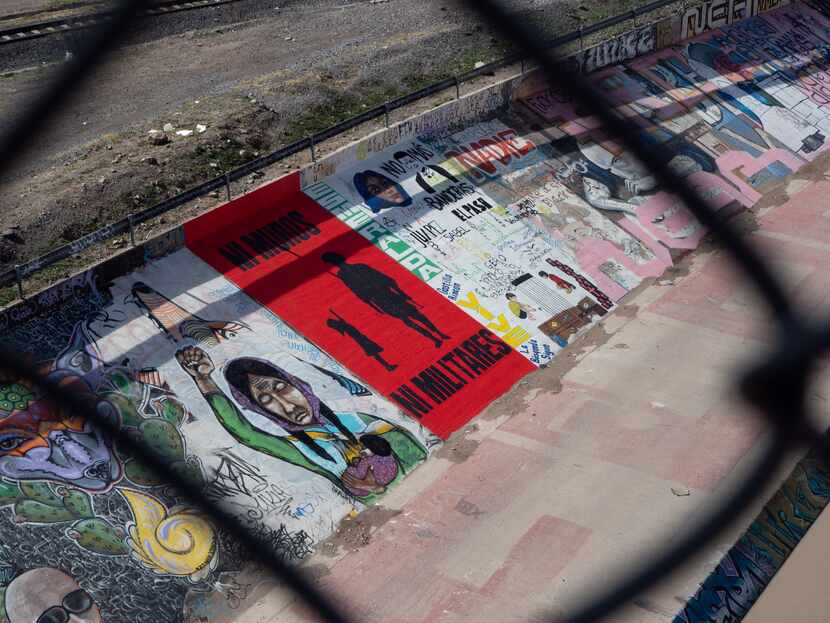 A fresh mural the Mexican side of the Rio Grande in Juarez reads, in red and black letters, ...