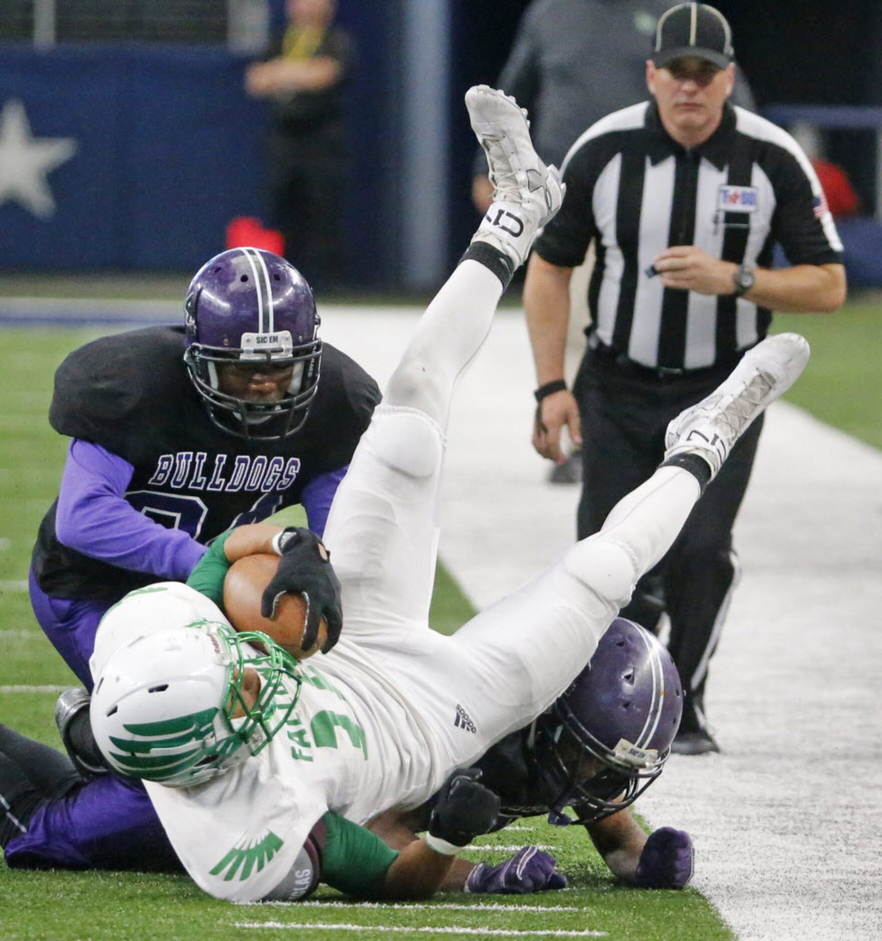 Lake Dallas receiver Tristan Bowen (36) is upended after catching a fourth-quarter pass...