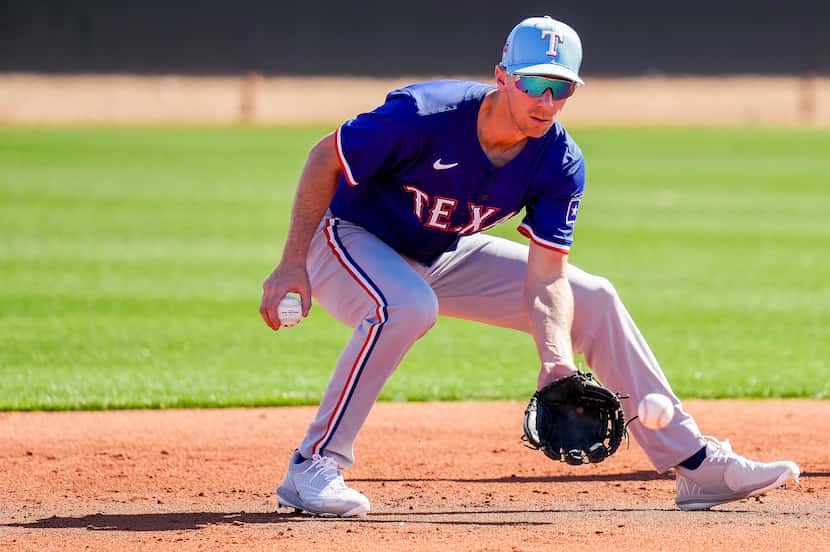 Texas Rangers infielder Matt Duffy participates in a fielding drill during the first full...