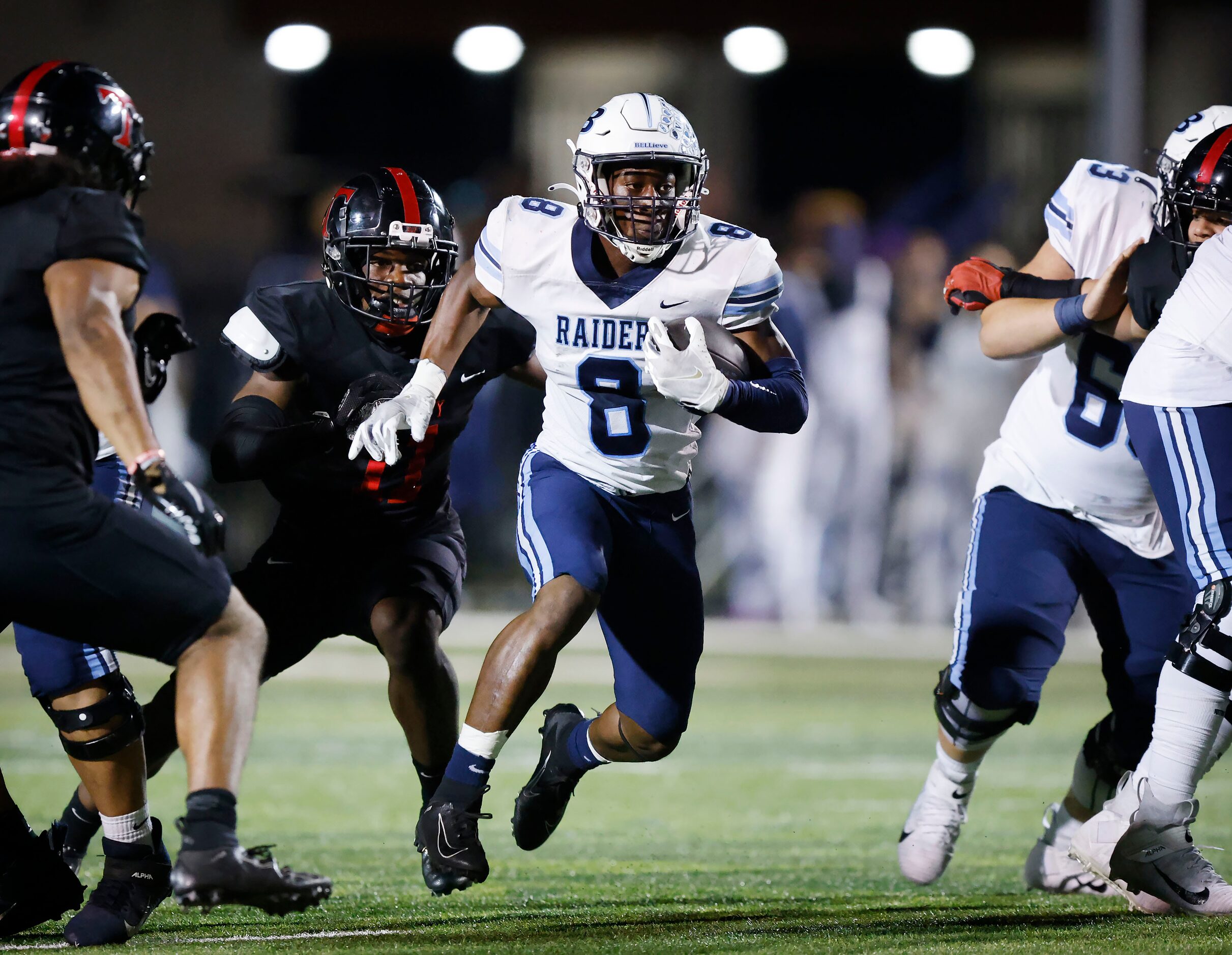 Hurst L.D. Bell running back Gracien Anto (8) races past Euless Trinity linebacker Javion...