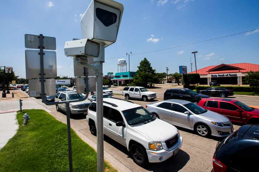 A red-light camera at Belt Line Road and southbound U.S. Highway 75 in Richardson stands...