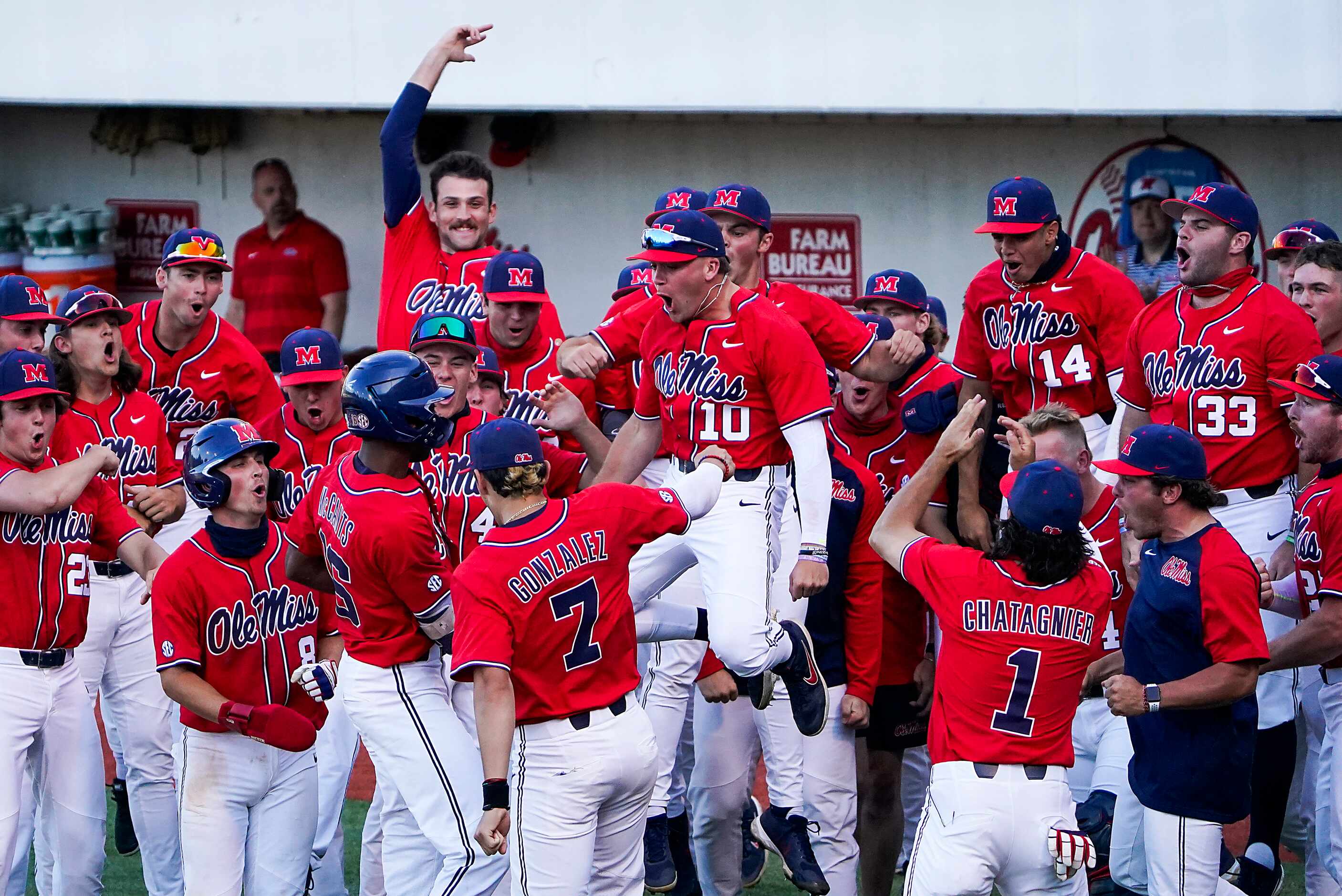 Mississippi outfielder John Rhys Plumlee (10) leaps into the celebration of a home run by...