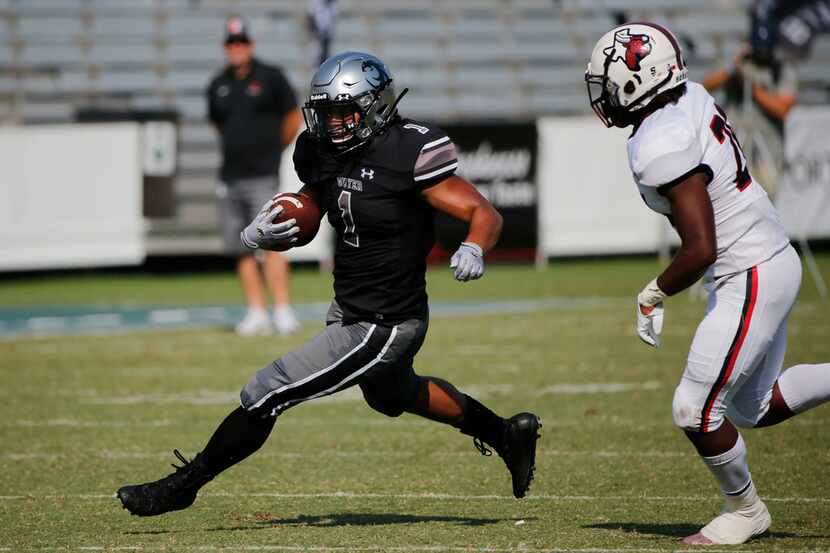 Denton Guyer running back Kaedric Cobbs (1) looks for running room against Cedar Hill on...