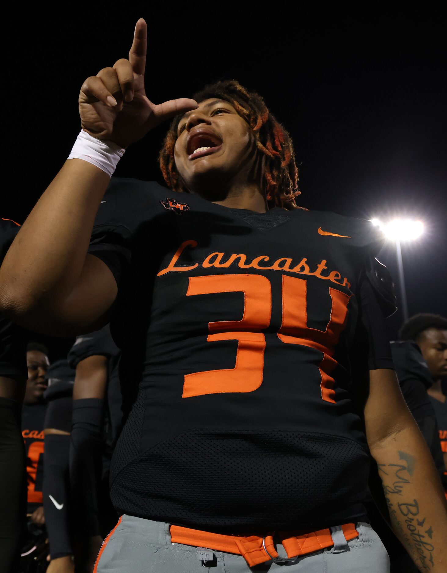 Lancaster defensive end Josh Brown (34) lets out a yell as the band finishes playing the...