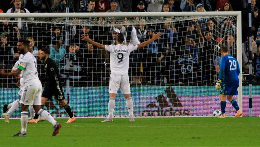 LA Galaxy forward Zlatan Ibrahimovic celebrates after netting a penalty kick past Sporting...