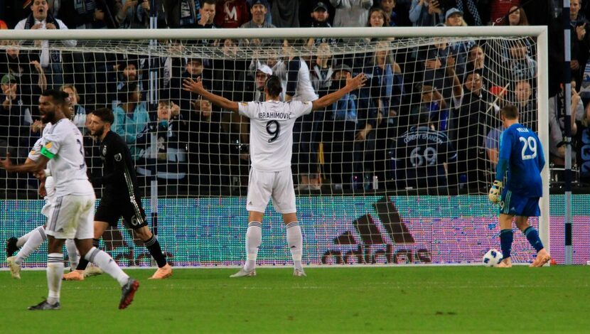 LA Galaxy forward Zlatan Ibrahimovic celebrates after netting a penalty kick past Sporting...