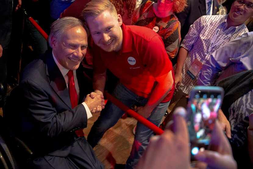 Texas Gov. Greg Abbott posed for a photo with a supporter during the Texas GOP election...