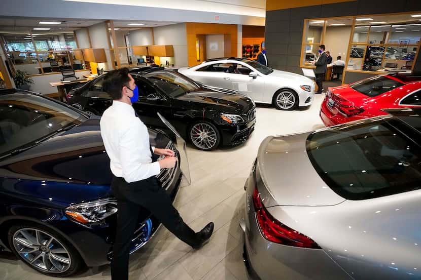 Sales Consultant Erik Bohdan walks through the showroom at Park Place Motorcars Dallas on...