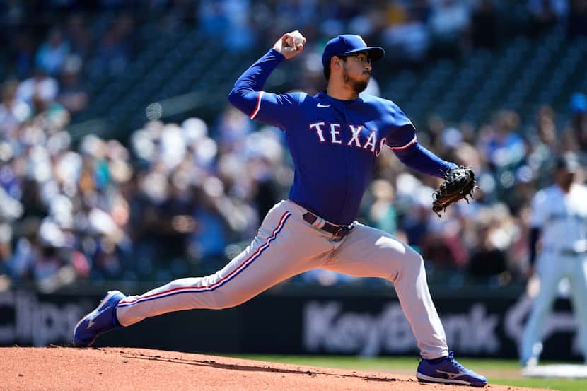 Texas Rangers starting pitcher Dane Dunning throws against the Seattle Mariners during the...