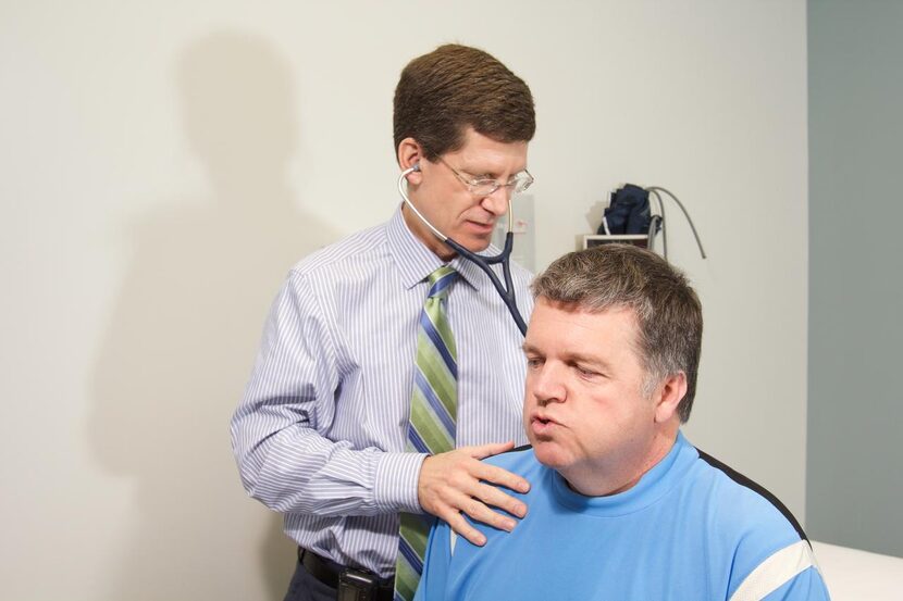 Yancy examines  a patient. Many programs include  a medical assessment.