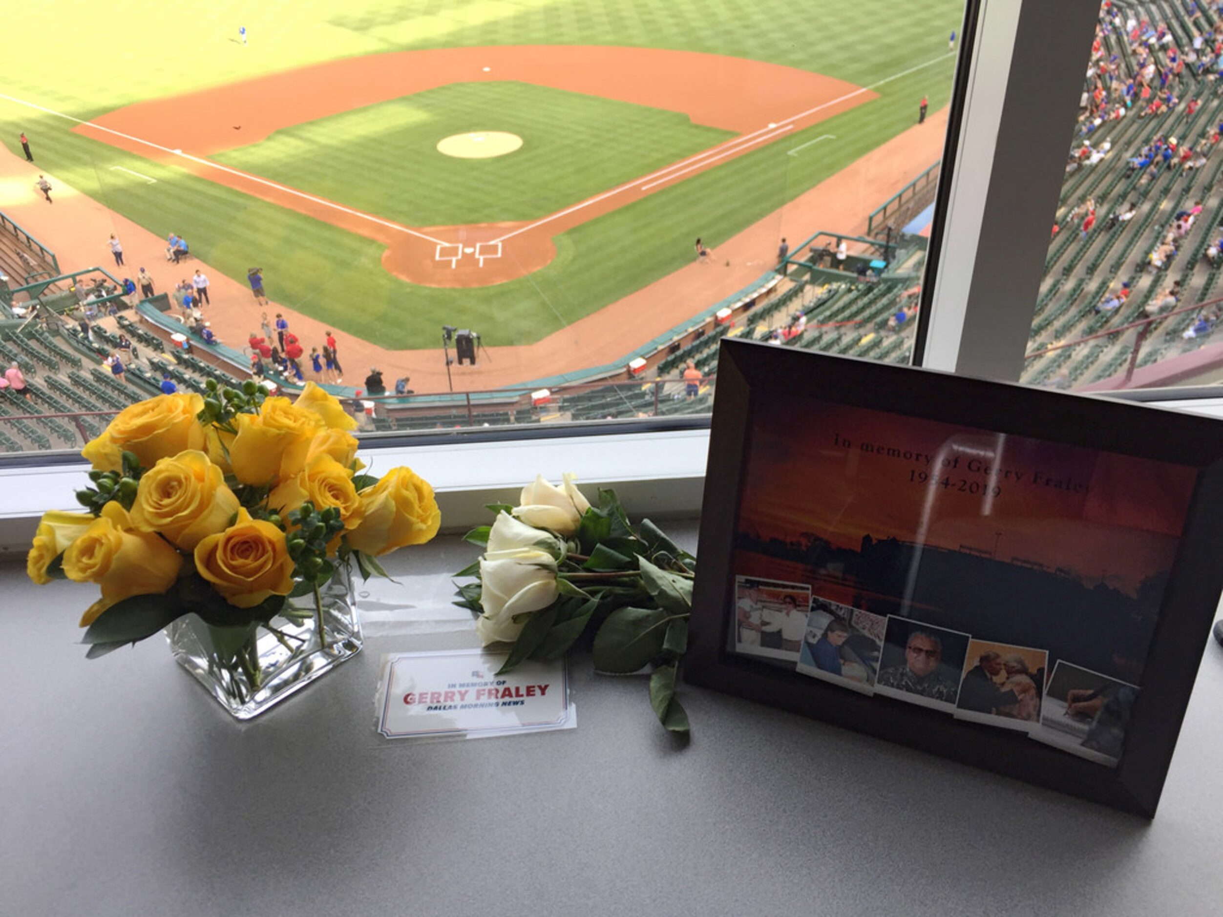 Flowers and a photo can be seen in sports reporter, Gerry Fraley, of The Dallas Morning News...