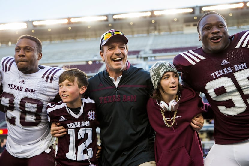 FILE - Texas A&M head coach Jimbo Fisher, center, sings the school song with his team after...