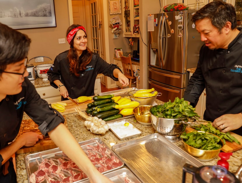 Emma, Peter and their son Preston Nguyen prepare food at their home for a catering order in...