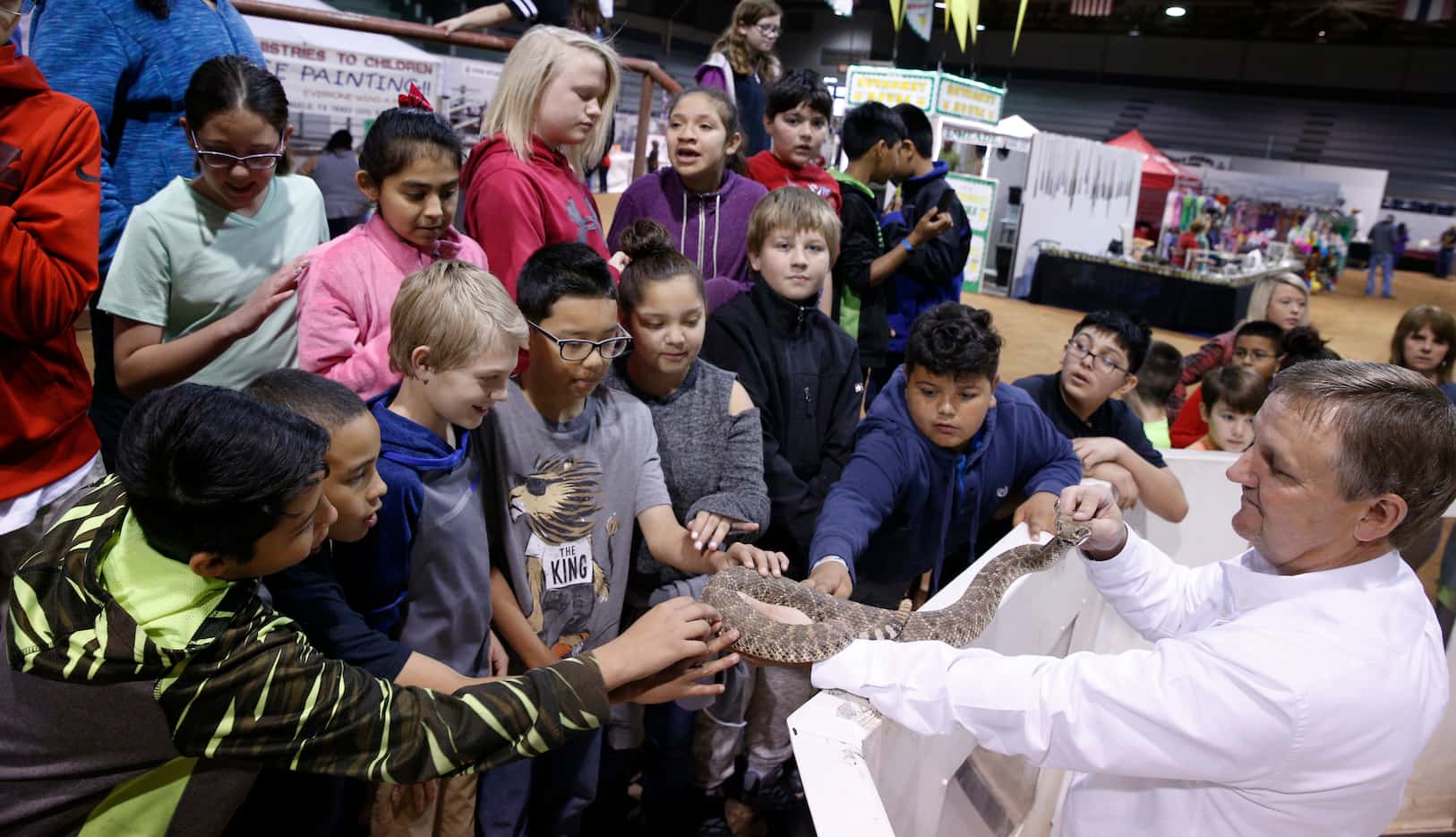 Dennis Cumbie allows children from Sweetwater Intermediate school to touch a live snake...