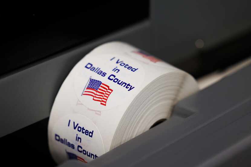 A roll of “I Voted in Dallas County” stickers awaited future voters at the county election...