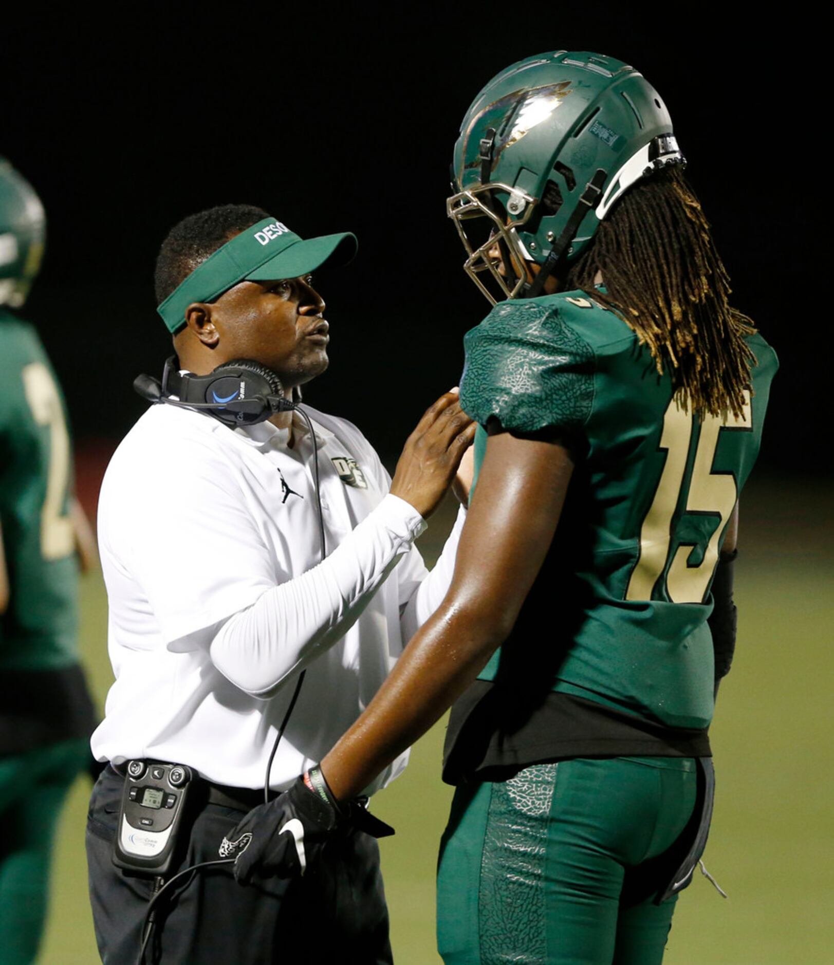 DeSoto's Claude Mathis talks with Desoto's Javon Charles (15) in a game against Mansfield...