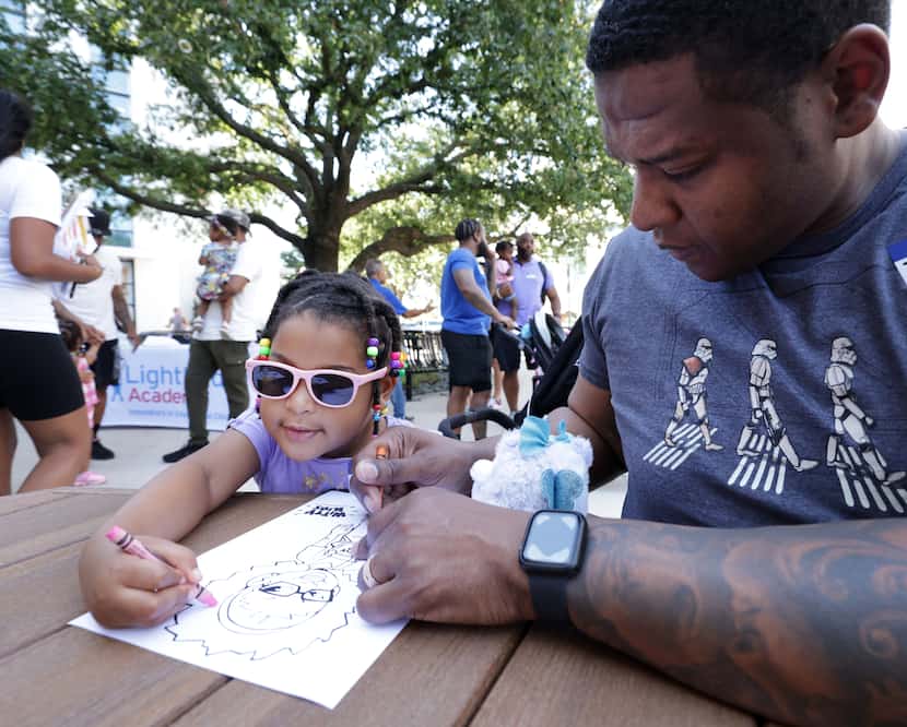 3-year-old Adrianna Grayer (left) and Darrell Grayer color during a Daddy Stroller Social...