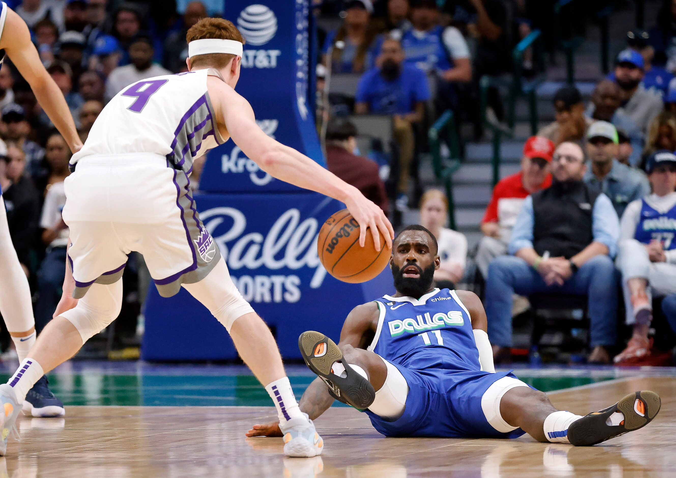 Dallas Mavericks forward Tim Hardaway Jr. (11) falls backwards as he is run into by...